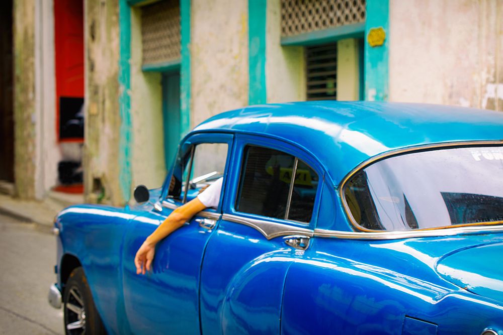 Man driving blue car