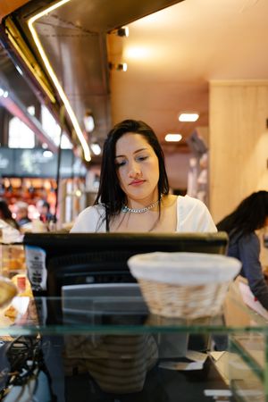 Woman using the screen of a cash register