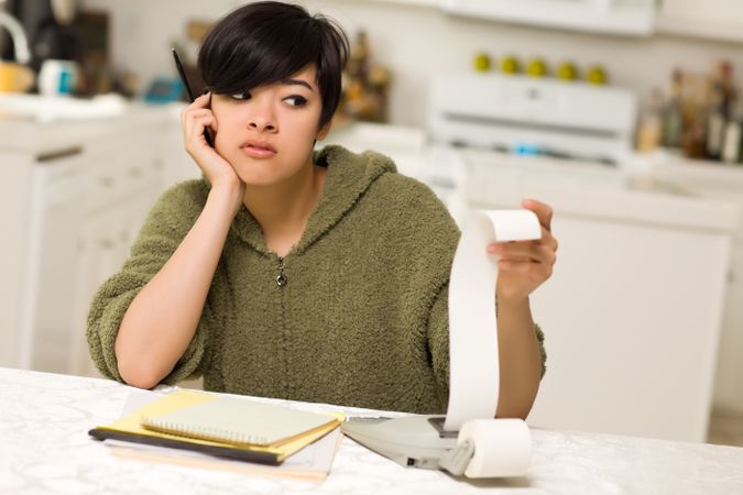 Young Woman Agonizing Over Financial Calculations