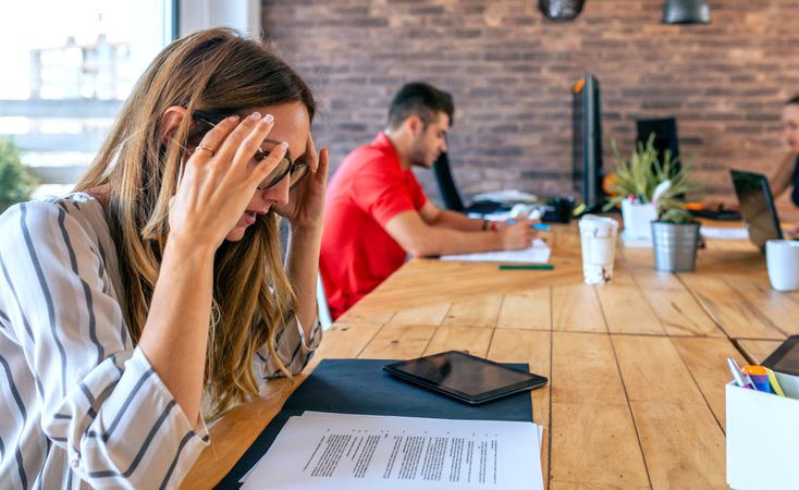 Stressed businesswoman with hands on head