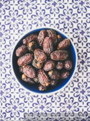 Top view bowl of dates on blue tiled surface 5pEjg4