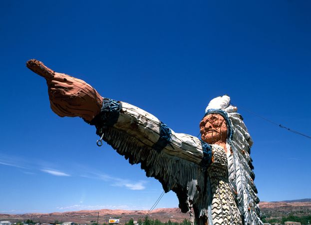 A wooden Native American statue in rural Utah