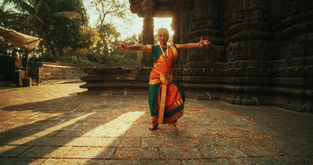 Female Indian Lead Dancer Explaining to her Team Dancers the Moves of a Traditional Choreography.