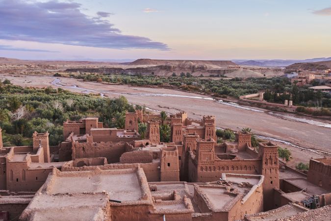 Ancient city near river in desert and wonderful sky