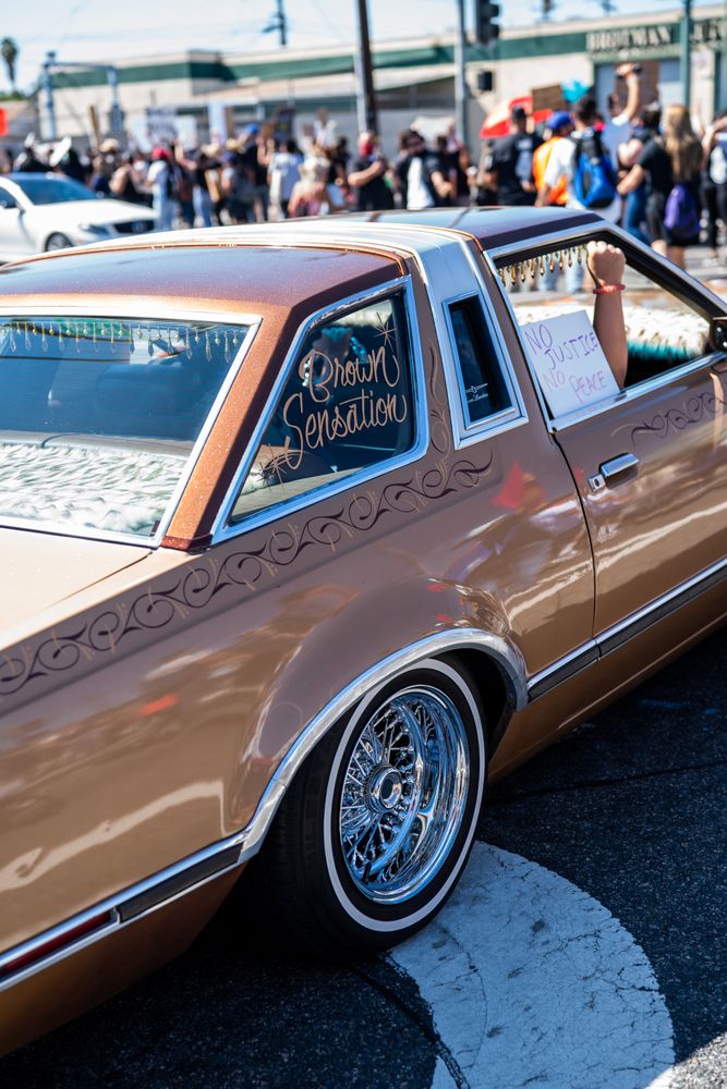 Los Angeles, CA, USA — June 7th, 2020: woman’s fist up from vintage car window at rally in East LA