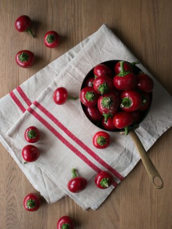 Pickled cherry peppers near napkin and twig
