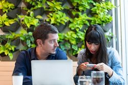 Male and female having meeting at coffee shop