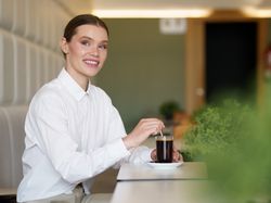 Elegant businesswoman drinking coffee in a cafeteria