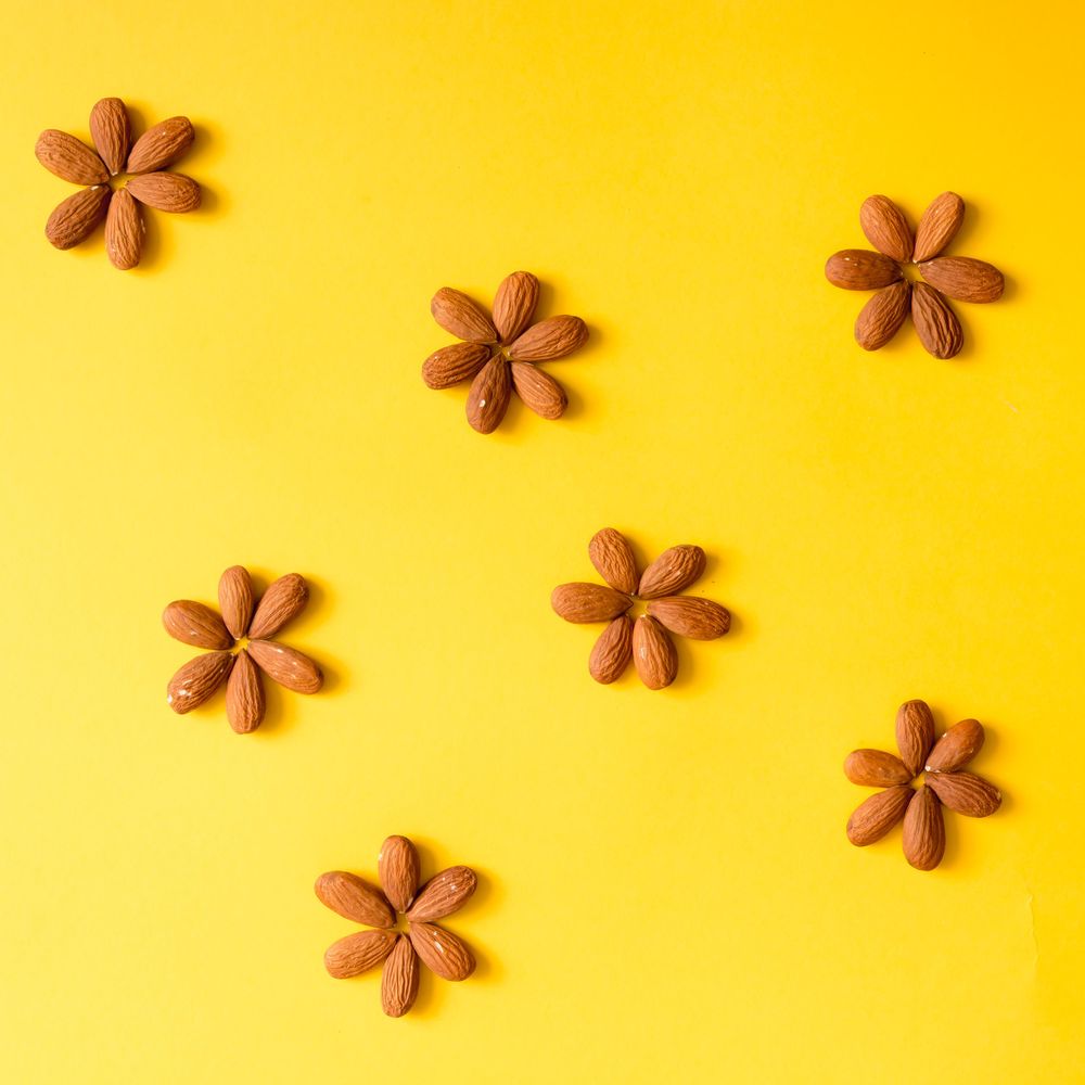 Almond in flower pattern on yellow background
