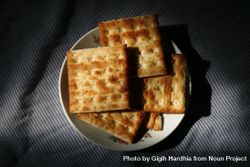 Top view of crackers on shadowy plate 4OAOv0