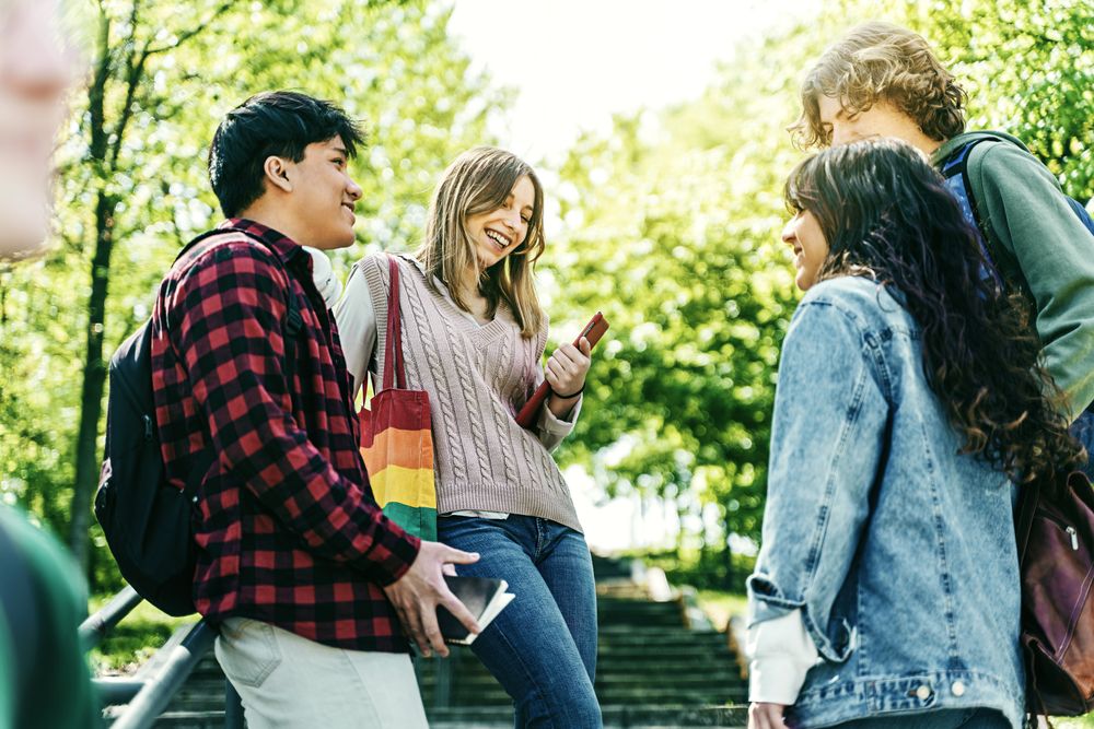 Young people adults chatting in park