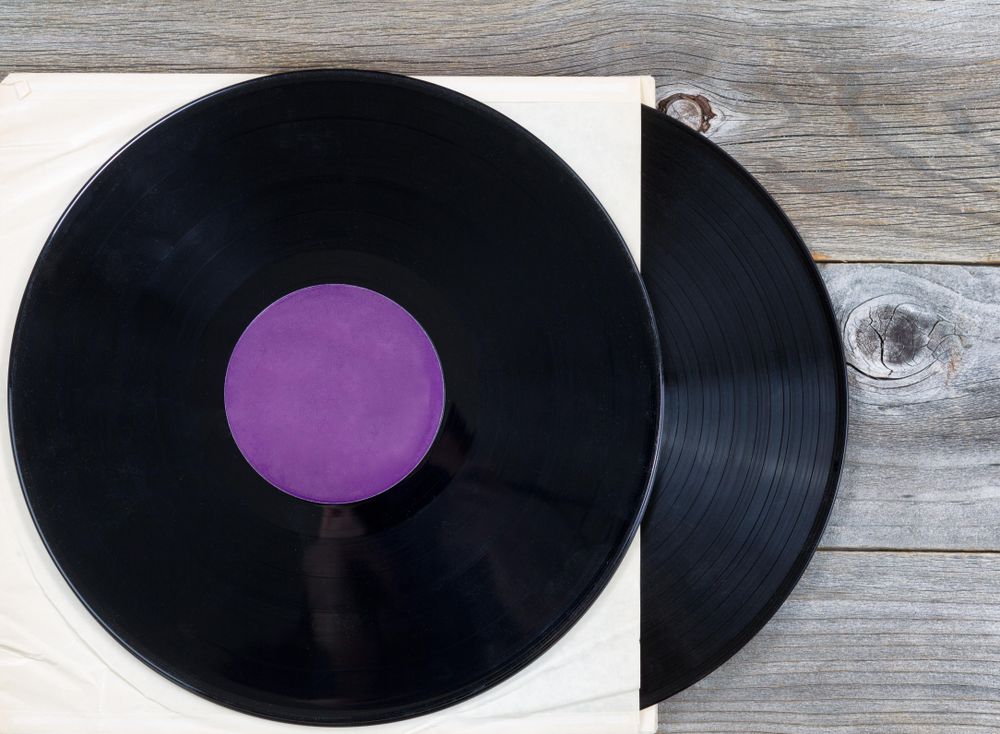 Stack of old music records on rustic wood