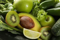 Green vegetables and fruits on whole background