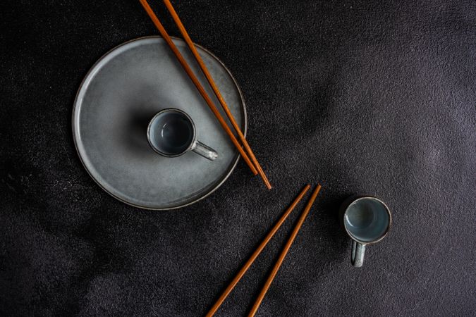 Asian table setting with wooden chop sticks and tea cups