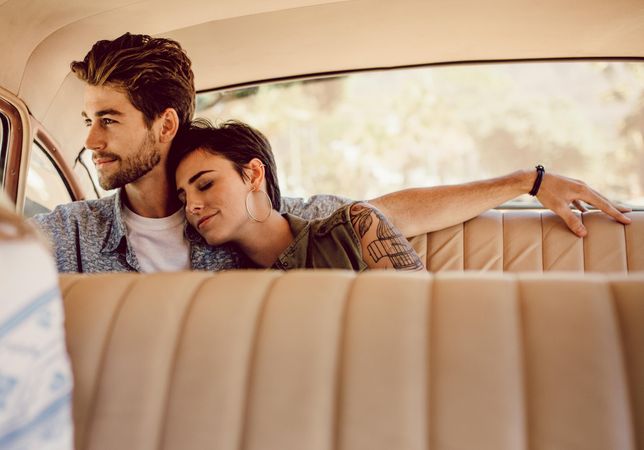 Couple traveling in a vintage car