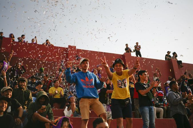 Kedira, East Java Indonesia - October 4, 2019:  Fans cheering at soccer game with confetti
