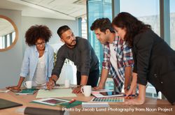 Team Of Designers Standing Around Table With Documents And Color ...