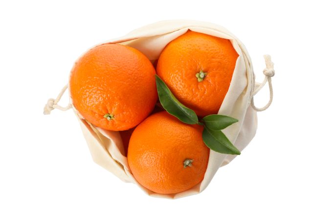 Cotton bag with ripe mandarins isolated on light background
