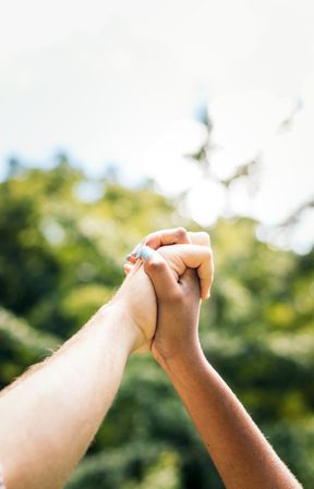 Interracial couple taking a walk hand in hand in the park