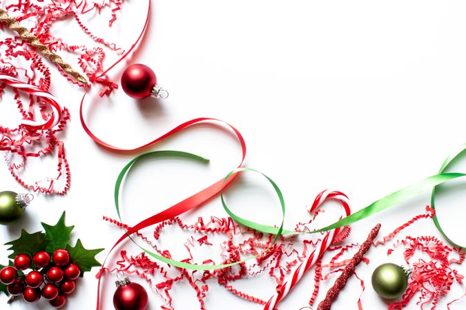 Christmas theme backdrop with red and green ornaments, ribbons, candy cane, and confetti.
