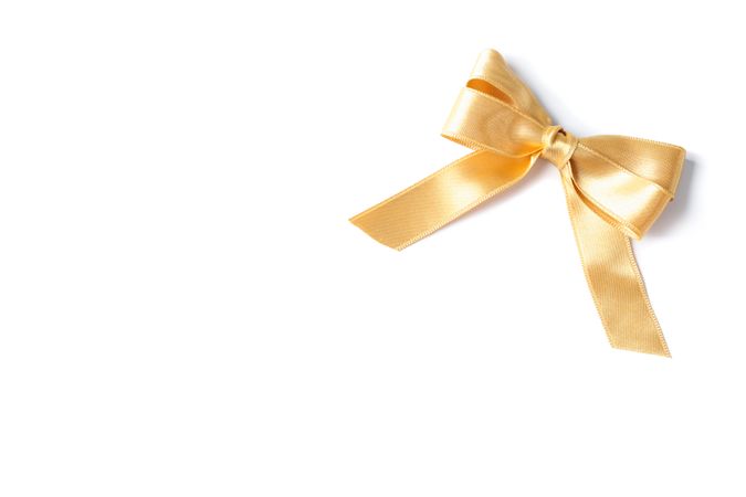 Gold bow isolated on plain background. Gift concept