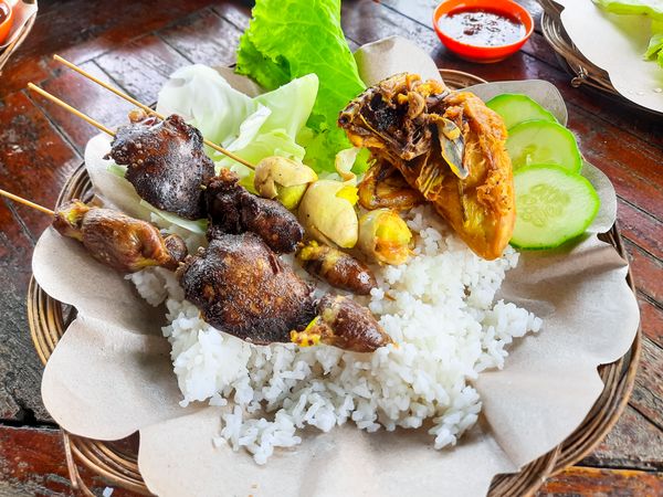 Traditional Indonesian food is called Ayam Penyet or fried chicken with rice and tempeh plus vegetables with chili sauce