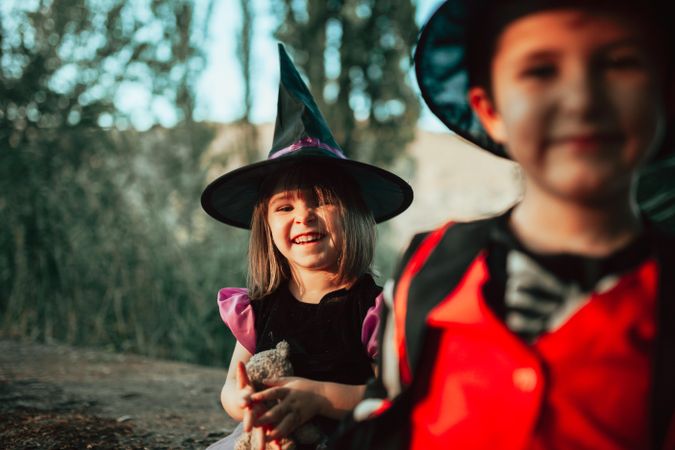 Brother and sister laughing in halloween costumes