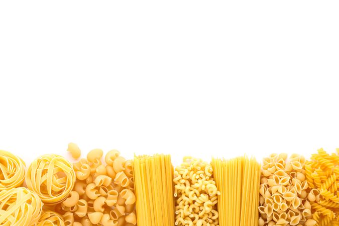 Pasta isolated on studio background, top view. Dry uncooked whole pasta