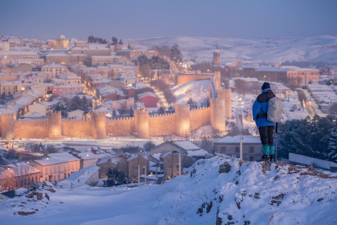 Hiker watching panorama of snowy town