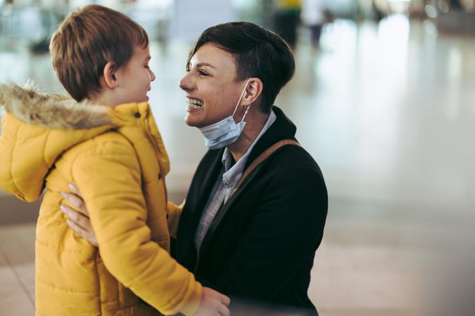 Woman meeting her son at airport after pandemic