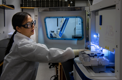 Female scientist performing one of the last steps in a poliovirus testing process