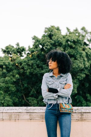 Fashionable Black female relaxing in city
