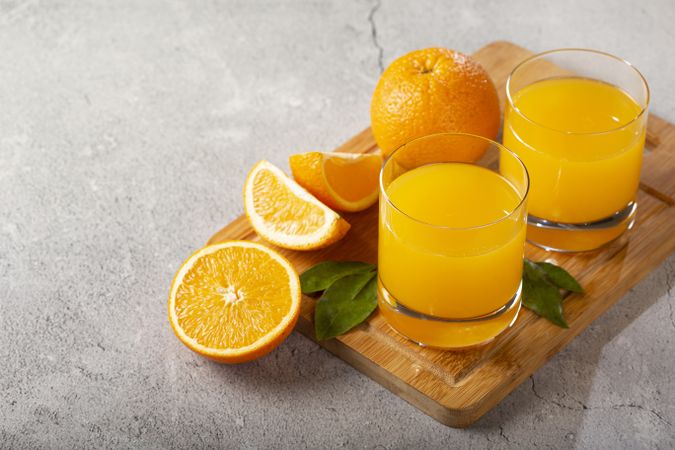 Glass with orange juice on the table.