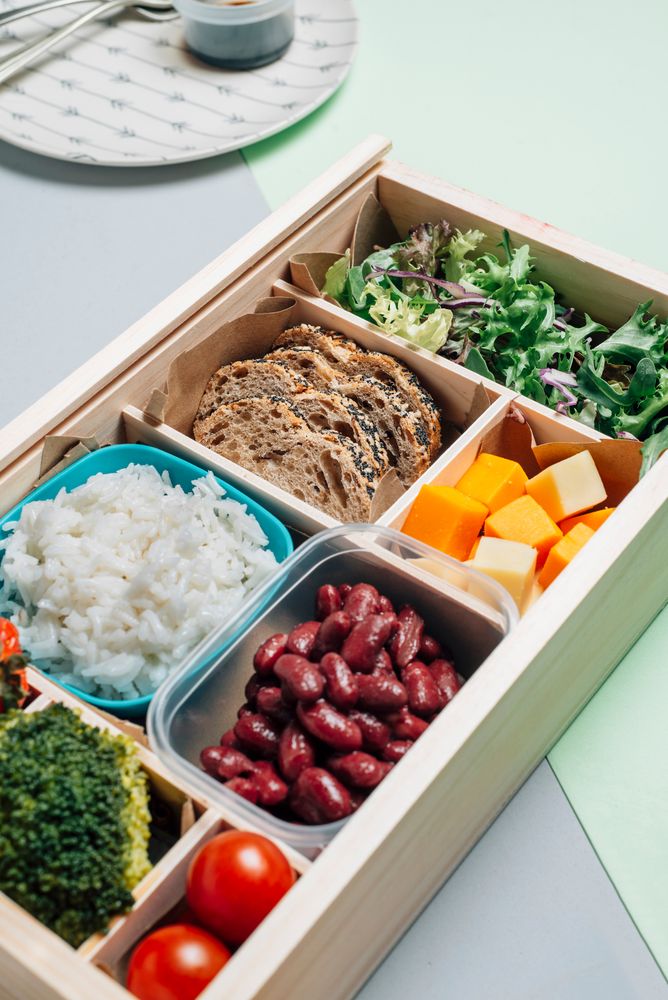 Food box with diet ingredients by copybook and plate
