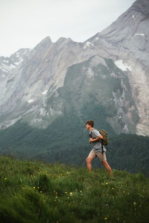 Unrecognizable man with backpack hiking in Pyrenees mountains