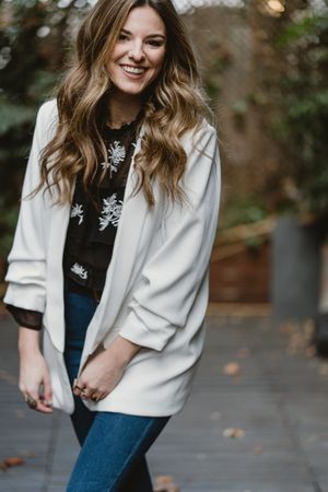 Woman standing on planter in garden