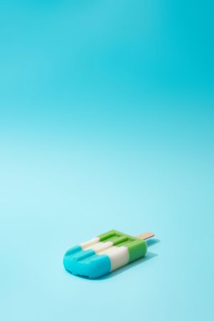 Colorful ice cream popsicle on bright blue background
