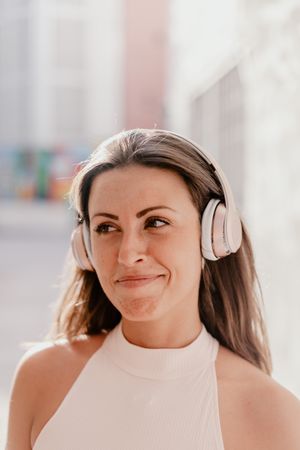 Brunette listening to music in sunlight