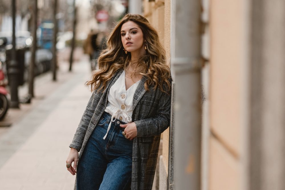Woman leaning on wall on street