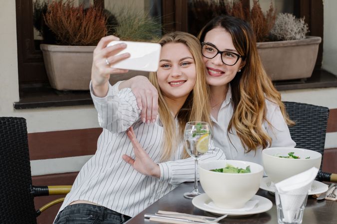 Young women taking selfie in restaurant