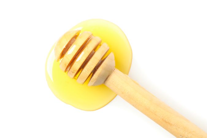 Dipper and honey isolated on blank background, top view