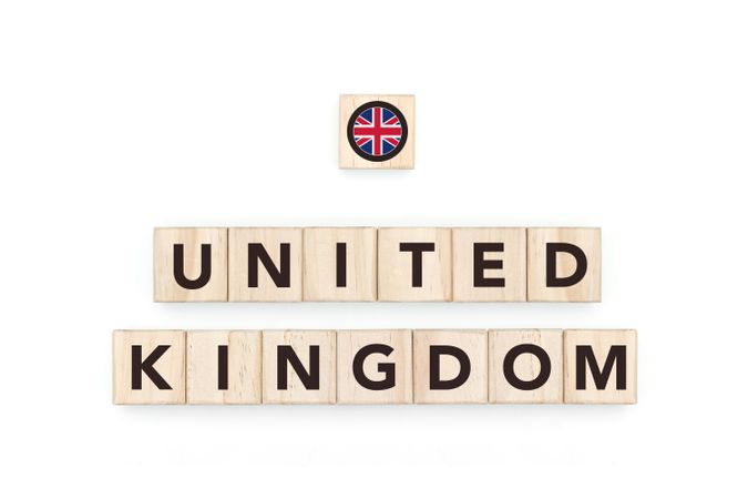 Wooden blocks bearing the name and flag of United Kingdom. British and European Culture, national identity, travel, and geography in a copy space design.
