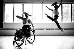 MONTREAL, QUEBEC, CANADA – August 29 2018- One woman in a wheelchair, another woman leaping