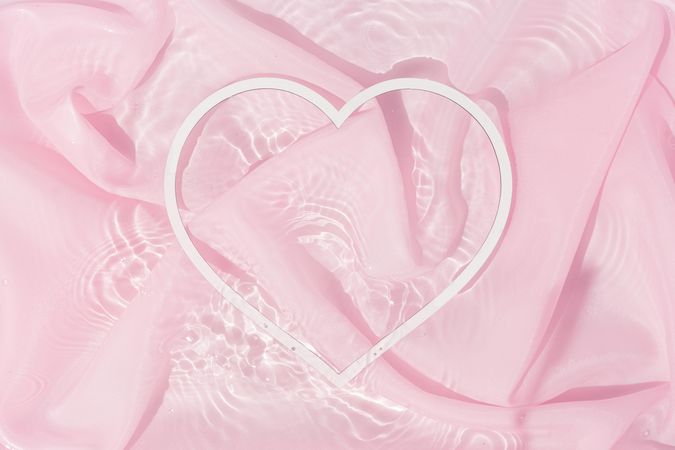Heart shape copy space in water with silk fabric