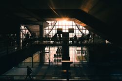 Airport gate silhouette with people, chairs and signs