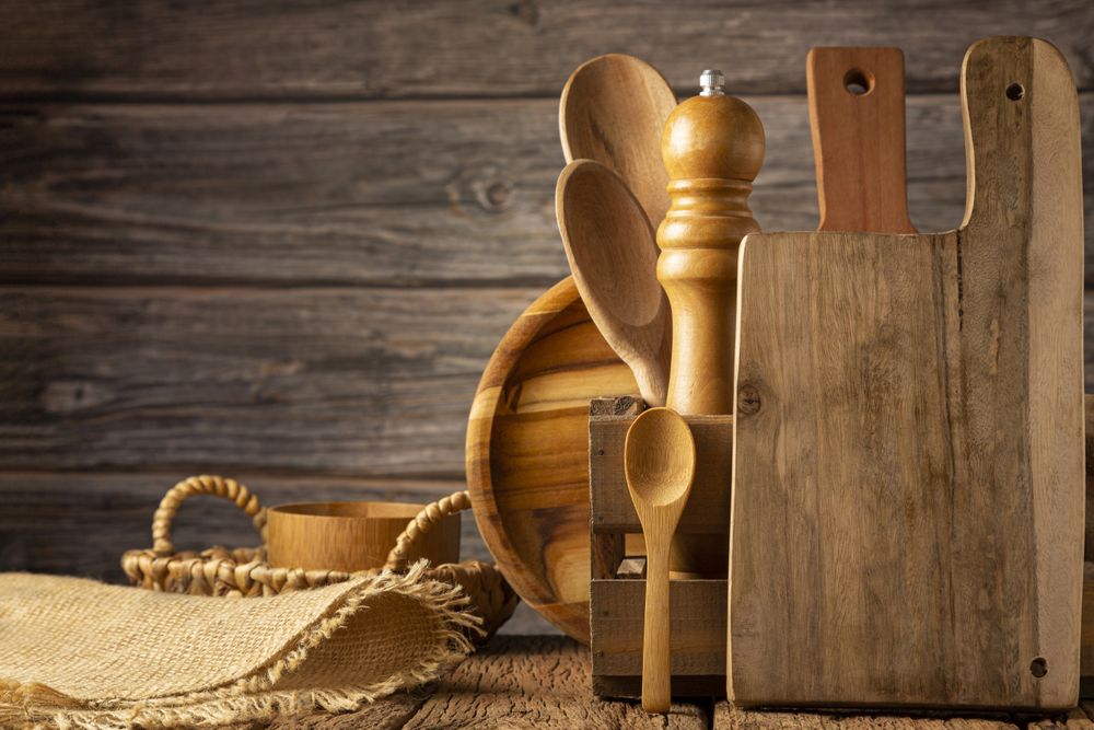 Wooden kitchen utensils on rustic background.