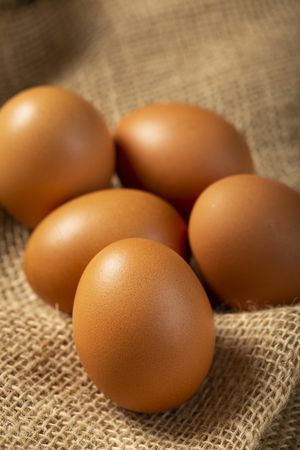 Brown chicken eggs rises on the table.