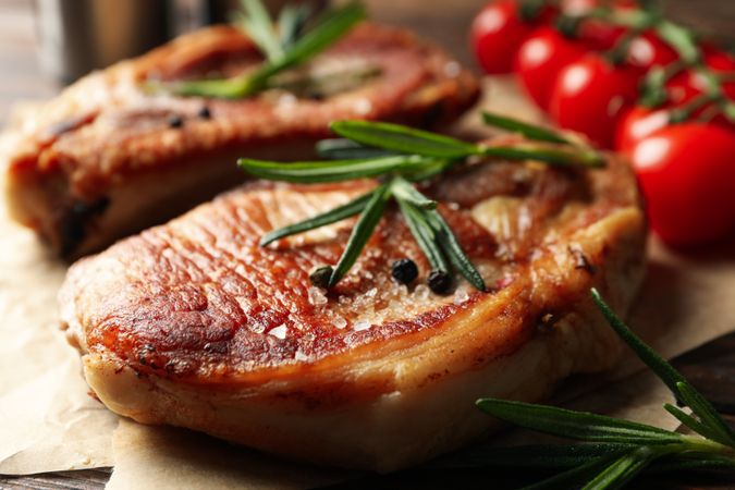 Composition with fried steaks on wooden background. Grilled food