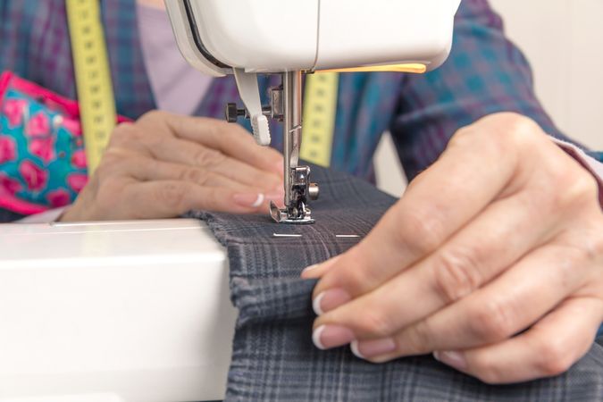 Seamstress hands working on a sewing machine