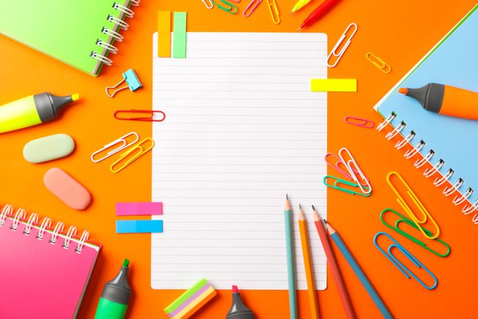 Flat lay composition with school supplies on color background, space for text